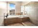 Spa-like bathroom with soaking tub, walk-in shower, and stunning views at 28990 N White Feather Ln # 130, Scottsdale, AZ 85262