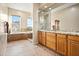 Elegant bathroom with double vanity, soaking tub, and large shower at 28990 N White Feather Ln # 130, Scottsdale, AZ 85262