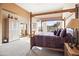 Bright bedroom with a wooden four-poster bed and mountain views at 28990 N White Feather Ln # 130, Scottsdale, AZ 85262