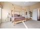 Bedroom with a wooden four-poster bed and access to a balcony at 28990 N White Feather Ln # 130, Scottsdale, AZ 85262