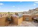 Outdoor kitchen with built-in grill, offering stunning mountain views at 28990 N White Feather Ln # 130, Scottsdale, AZ 85262