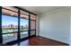 Comfortable bedroom features hardwood floors and floor-to-ceiling windows at 310 S 4Th St # 2202, Phoenix, AZ 85004