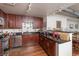 Modern kitchen with dark granite counters, dark hardwood cabinets, and a stainless steel dishwasher at 310 S 4Th St # 2202, Phoenix, AZ 85004