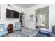 Cozy living room space showing an open doorway, plush rug, and flat screen TV at 310 S 4Th St # 2202, Phoenix, AZ 85004