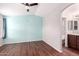 Light-blue and gray bedroom with wood-look floors and ensuite bathroom access at 3104 E Broadway Rd # 9, Mesa, AZ 85204