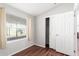 Bedroom with wood-look floors, large window, and sliding door closet at 3104 E Broadway Rd # 9, Mesa, AZ 85204