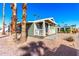 Mobile home with front porch and palm trees at 3104 E Broadway Rd # 9, Mesa, AZ 85204