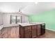 Modern kitchen features island with sink, dark brown cabinets, and black dishwasher at 3104 E Broadway Rd # 9, Mesa, AZ 85204