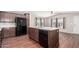 Modern kitchen with island, dark cabinets, and black appliances at 3104 E Broadway Rd # 9, Mesa, AZ 85204