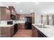 Modern kitchen with dark wood cabinets and stainless steel appliances at 3104 E Broadway Rd # 9, Mesa, AZ 85204