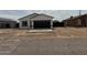 Beautiful home featuring a modern white stucco exterior, black trim, and an attached two-car garage at 3215 W Sueno Dr, Eloy, AZ 85131