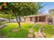 Landscaped backyard with fruit trees and flagstone path at 3249 W Maryland Ave, Phoenix, AZ 85017