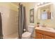 Simple bathroom with shower/tub combo and wood vanity at 3249 W Maryland Ave, Phoenix, AZ 85017