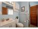 Clean bathroom with shower, grab bars, and a vanity with a large mirror at 3249 W Maryland Ave, Phoenix, AZ 85017