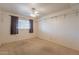 Simple bedroom with carpeted floor and window with curtains at 3249 W Maryland Ave, Phoenix, AZ 85017