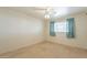 Bright bedroom with carpeted floor and window with light teal curtains at 3249 W Maryland Ave, Phoenix, AZ 85017