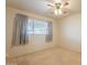 Simple bedroom with carpeted floor and window with curtains at 3249 W Maryland Ave, Phoenix, AZ 85017