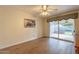 Bright Gathering room featuring wood-look floors and sliding glass doors to backyard at 3249 W Maryland Ave, Phoenix, AZ 85017