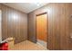 Small hallway with wood-paneled walls and patterned tile floor at 3249 W Maryland Ave, Phoenix, AZ 85017