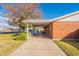 Side view of brick house with covered carport and landscaping at 3249 W Maryland Ave, Phoenix, AZ 85017