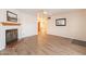 Living room with fireplace, wood floors, and view to hallway at 3249 W Maryland Ave, Phoenix, AZ 85017