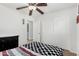 Comfortable bedroom features a ceiling fan, closet, and a chest of drawers at 3451 E Tyson St, Gilbert, AZ 85295