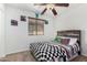 Cozy bedroom with a ceiling fan, window, and comic book themed decor at 3451 E Tyson St, Gilbert, AZ 85295