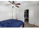 Bright bedroom with a ceiling fan, closet and doorway to another room at 3451 E Tyson St, Gilbert, AZ 85295