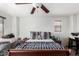 Bedroom features carpet flooring, ceiling fan, a queen bed, and a window with blinds at 3451 E Tyson St, Gilbert, AZ 85295