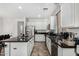 Bright kitchen features white cabinetry, stainless steel appliances, dark countertops, and a view to the dining room at 3451 E Tyson St, Gilbert, AZ 85295