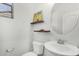 Powder room with floating shelves, sunflower decor, and a round mirror at 3451 E Tyson St, Gilbert, AZ 85295