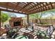 Relaxing patio with stone fireplace and pergola at 3554 N Hooper St, Buckeye, AZ 85396