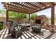 Relaxing patio with stone fireplace and pergola at 3554 N Hooper St, Buckeye, AZ 85396