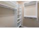 Spacious walk-in closet with built-in shelves and hanging rods at 4027 E Pueblo Ave, Mesa, AZ 85206