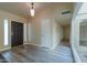 Bright entryway with wood-look flooring and a dark wood front door at 4027 E Pueblo Ave, Mesa, AZ 85206