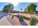 Landscaped front yard with mature trees and a long driveway at 4027 E Pueblo Ave, Mesa, AZ 85206