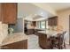 Modern kitchen with granite countertops and dark wood cabinetry at 4027 E Pueblo Ave, Mesa, AZ 85206