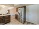 Stainless steel refrigerator in kitchen with wood cabinetry at 4027 E Pueblo Ave, Mesa, AZ 85206