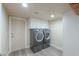 Bright laundry room, featuring washer, dryer, and ample storage at 4027 E Pueblo Ave, Mesa, AZ 85206