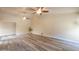 Open living room with wood-look floors and ceiling fans at 4027 E Pueblo Ave, Mesa, AZ 85206