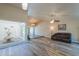 Spacious living room with wood-look floors and a leather couch at 4027 E Pueblo Ave, Mesa, AZ 85206