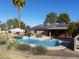 Relaxing pool area with patio furniture and solar panels at 4027 E Pueblo Ave, Mesa, AZ 85206