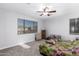 Bright bedroom with carpeted floor, ceiling fan and large window at 4332 E Vallejo Ct, Gilbert, AZ 85298