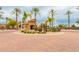 Community entrance with palm trees and a guardhouse at 4332 E Vallejo Ct, Gilbert, AZ 85298