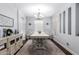 Formal dining room with hardwood floors, a white table, and decorative accents at 4332 E Vallejo Ct, Gilbert, AZ 85298