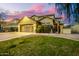 Charming two-story home with well-manicured front yard and desert landscaping at dusk at 4332 E Vallejo Ct, Gilbert, AZ 85298