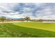 Scenic golf course view with lake and homes in background at 4332 E Vallejo Ct, Gilbert, AZ 85298