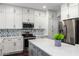 Modern kitchen with white cabinets, quartz countertops, and a stylish backsplash at 4332 E Vallejo Ct, Gilbert, AZ 85298