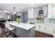 Bright kitchen with white cabinets, an island, and a view into the living area at 4332 E Vallejo Ct, Gilbert, AZ 85298