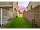 Narrow strip of artificial turf along the side of the house secured by walls and fencing at 4332 E Vallejo Ct, Gilbert, AZ 85298